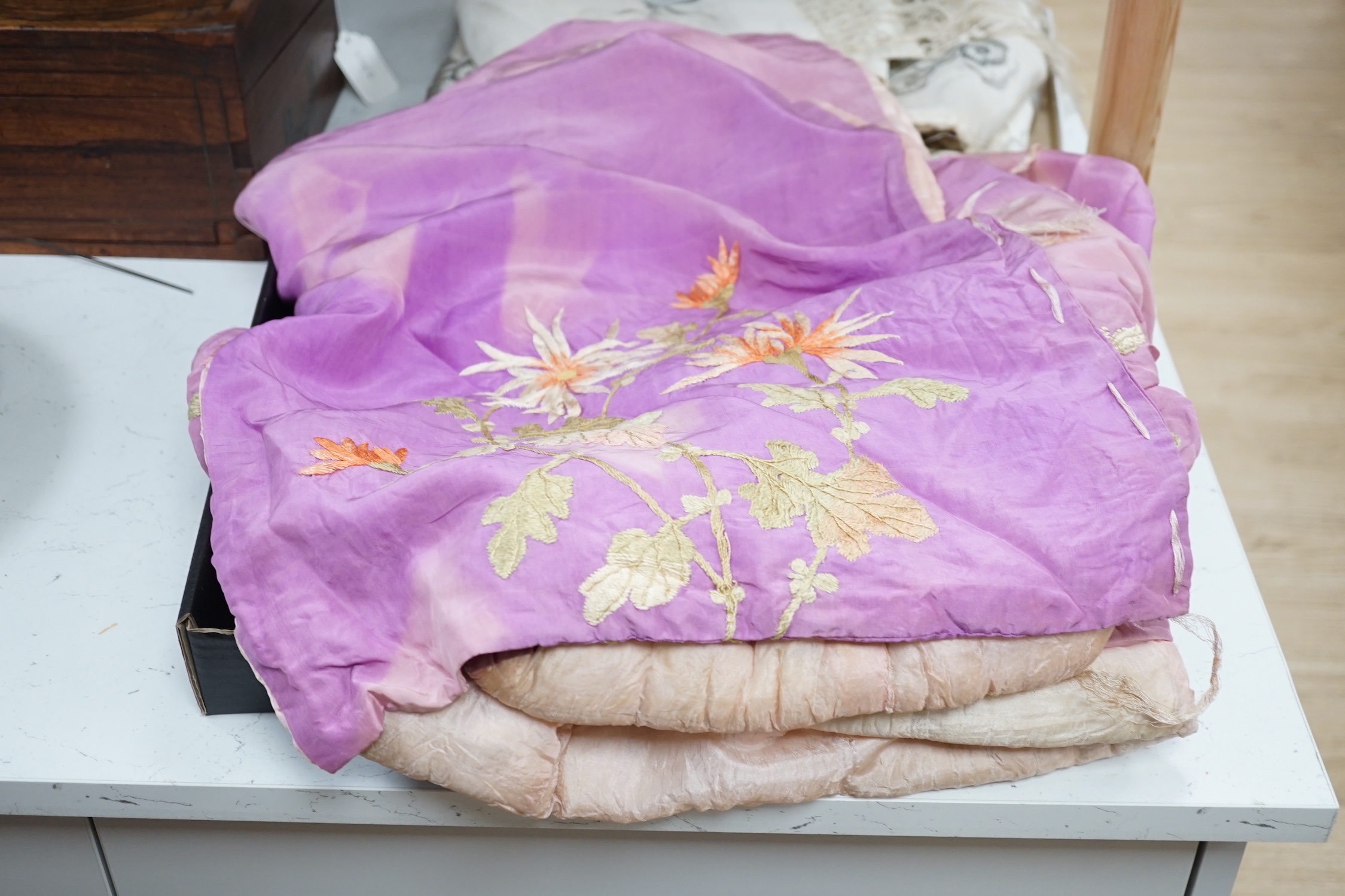 A Japanese silk kimono embroidered on mauve silk with multi-coloured butterflies and flowers, together with a cream silk unmade up kimono richly embroidered with a dragon design